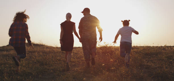 istock Soldier and his family walking on a meadow 1177656538