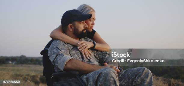 Wife Hugging Wheelchaired Husband Stock Photo - Download Image Now - Veteran, Wife, Consoling