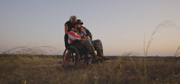 Disabled soldier watching sunset with family