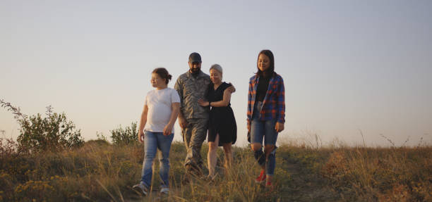 istock Soldier and his family walking on a meadow 1177656575