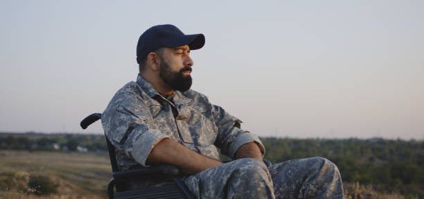 istock Wheelchaired soldier looking away into distance 1177656604