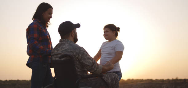 istock Wheelchaired soldier being together with family 1177656606