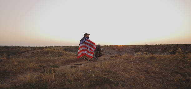 istock American soldier in wheelchair watching sunset 1177656626