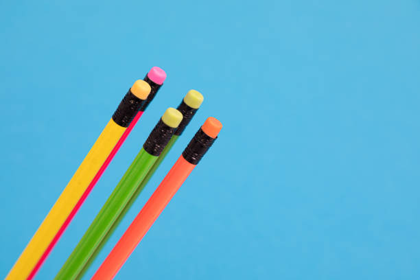 istock Five varicoloured crayons are loosely and diagonally arranged on a pale-blue surface isolated 1177657187