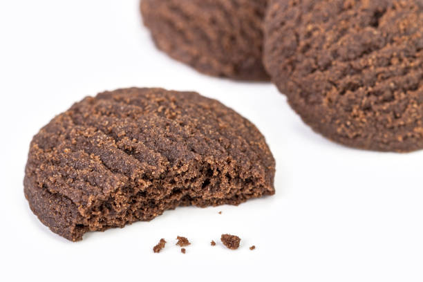 Dilicious chocolate rounded cookies on white plate with bite marks