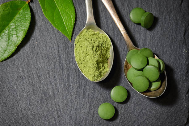 istock Chlorella And Barley Powder On Spoons on ardesia plate 1177670414