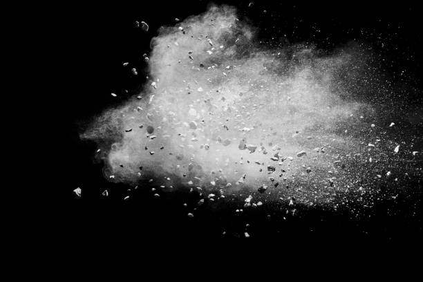 Split debris of stone exploding with white powder against black background. Split debris of stone exploding with white powder against black background. particle stock pictures, royalty-free photos & images