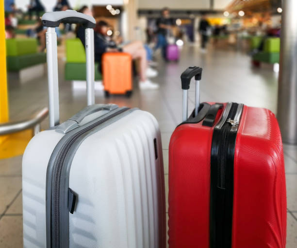 istock Travelers with suitcases walking inside the airport 1177683695