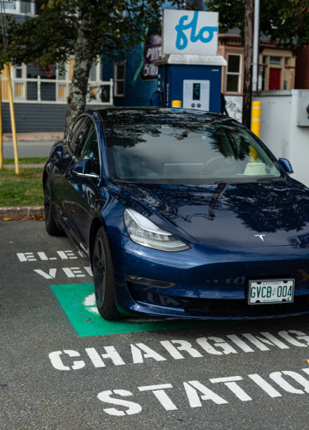 Charging Tesla Model 3 Halifax, Canada - September 26, 2019 - A Tesla Model 3 sedan is charged at a FLOnetwork electric car charging station in Halifax's South End. tesla model 3 stock pictures, royalty-free photos & images