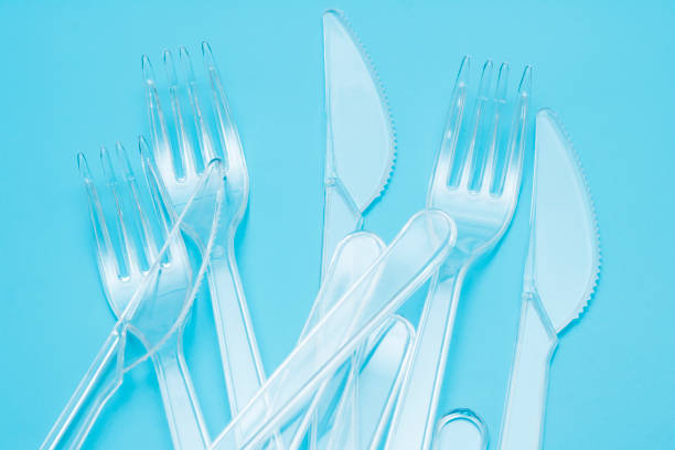 istock Plastic disposable tableware, cutlery. Fast food. Clean plastic forks and knives on blue background. Disposable dishes, environmental pollution. Top view, flat lay. 1177687114