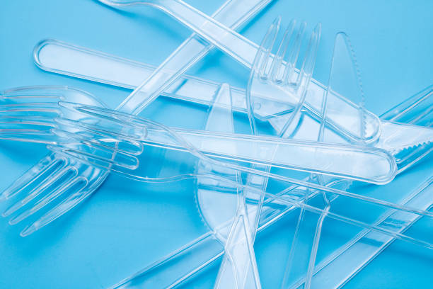 istock Plastic disposable tableware, cutlery. Fast food. Clean plastic forks and knives on blue background. Disposable dishes, environmental pollution. 1177687116