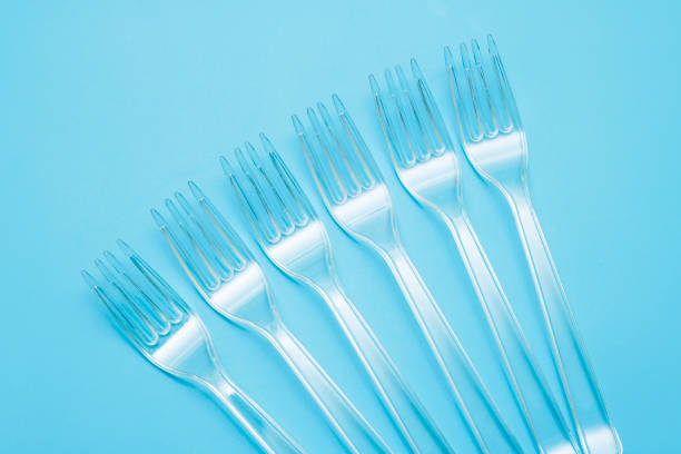 istock Plastic disposable tableware, cutlery. Fast food. Clean plastic forks on blue background. Disposable dishes, environmental pollution. 1177687118