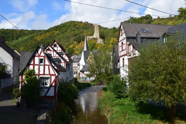 istock river Elz through Monreal old town with a ruin tower in bachground 1177687535