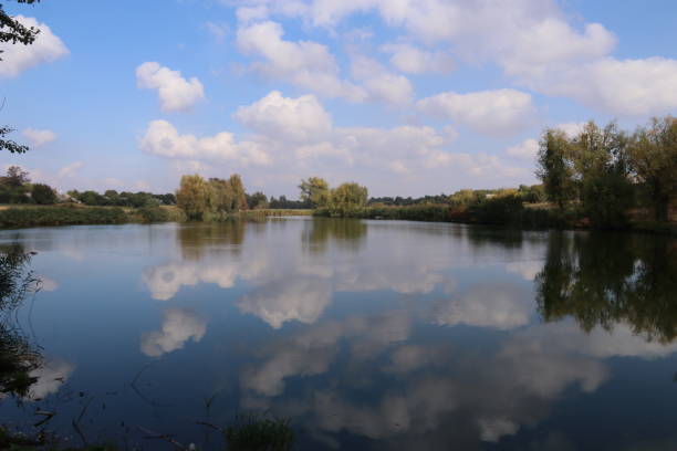 istock Clouds reflecting in the water of lake 1177687583