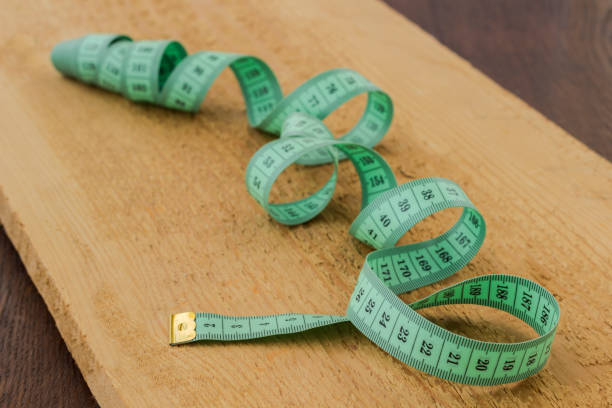 istock Green measuring tape on a blackboard, close-up 1177694472