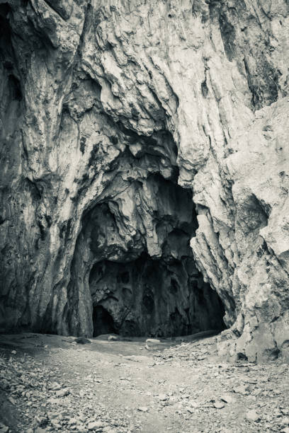 istock cave entrance in black and white 1177697416