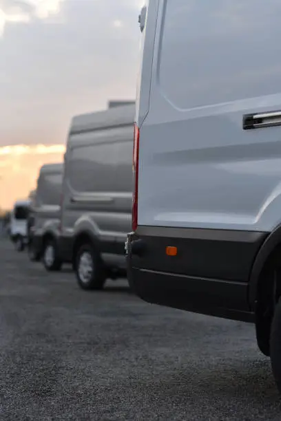 delivery vans parked in row in selective focus