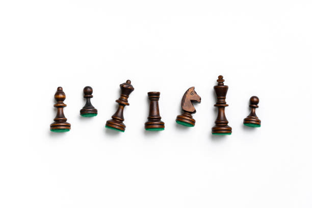 Golden chess pieces in a white background.