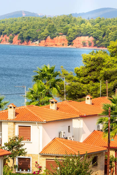 Nikiti, Sithonia, Chalkidiki Peninsula, Greece panorama with houses, blue sea and red rocks mountains