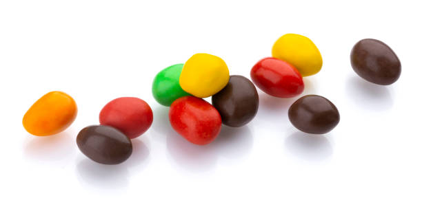 istock Multicolor shiny nuts and raisins dragee isolated on white background 1177702808