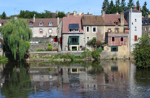 Fresnay-Sur-Sarthe, France, July 15 2017: Colorful houses on the River Sarthe,as it flows through Fresnay. It is a small historic town in Pays de la Loire, and a less well known tourist destination