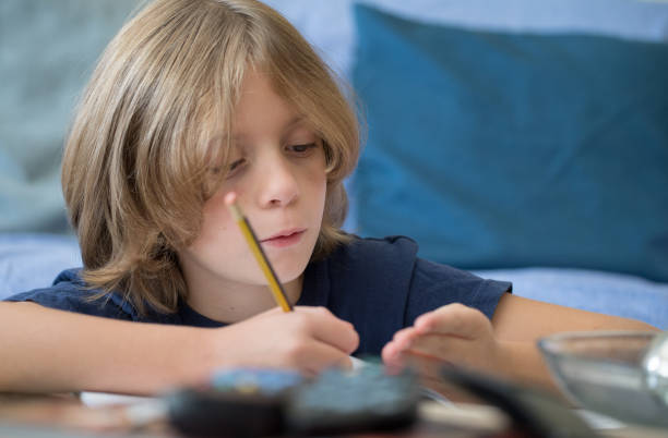 istock Young boy aged 9 studying and doing homework at home 1177706307
