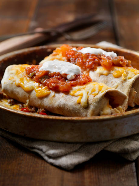 Cheesy Baked Beef Burrito Cheesy Baked Beef Burrito enchilada stock pictures, royalty-free photos & images