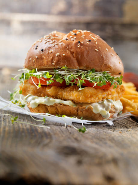 istock Crispy Fish Burger with Tarter Sauce, Micro Greens, Tomato on a Brioche Bun 1177706750