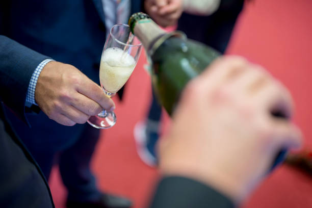 istock Filling champagne flutes at a party 1177707501