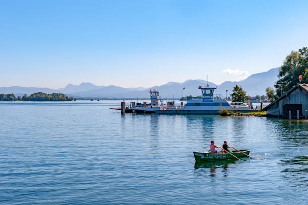 A couple are boating on Chiemsee lak in Bavaria, Germany.
