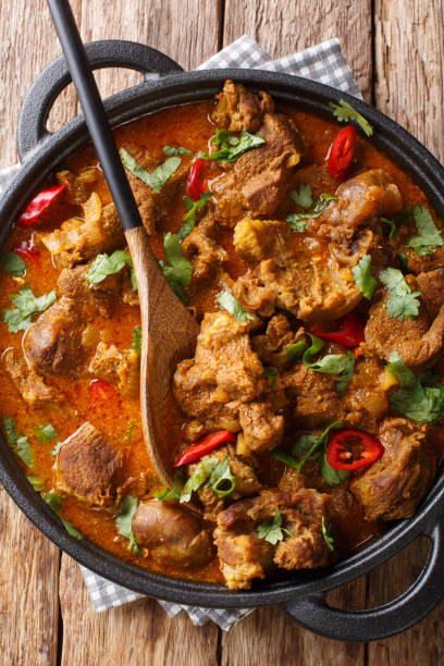 istock Lamb rogan josh close-up in a pan. Vertical top view 1177710696