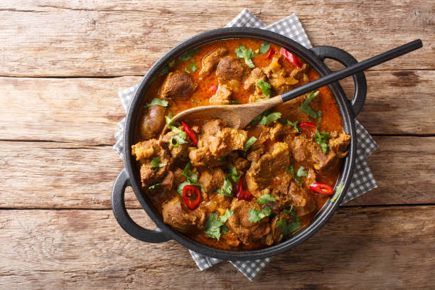 Kashmiri Lamb rogan josh with spices and gravy close-up in a pan. Horizontal top view Kashmiri Lamb rogan josh with spices and gravy close-up in a pan on the table. Horizontal top view from above masala stock pictures, royalty-free photos & images