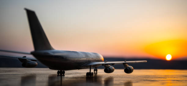 istock Artwork decoration. White passenger plane ready to taking off from airport runway. Silhouette of Aircraft during sunset time. 1177712625