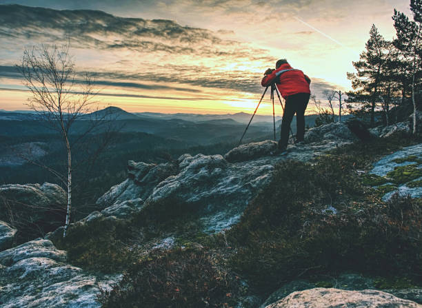 istock Alone hiker photographer in warm red jacket stand on peak 1177713244