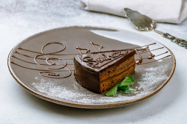 Sacher chocolate cake on grey stone table
