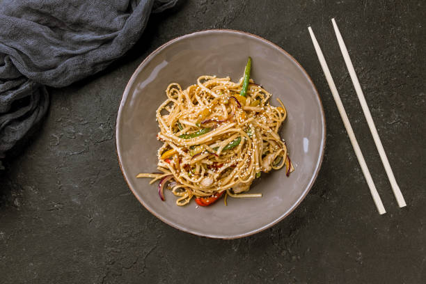 istock chicken wok noodles on dark stone table 1177714931