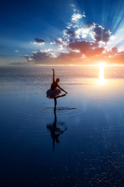 istock Ballerina dancing on the lake at sunset. 1177719491
