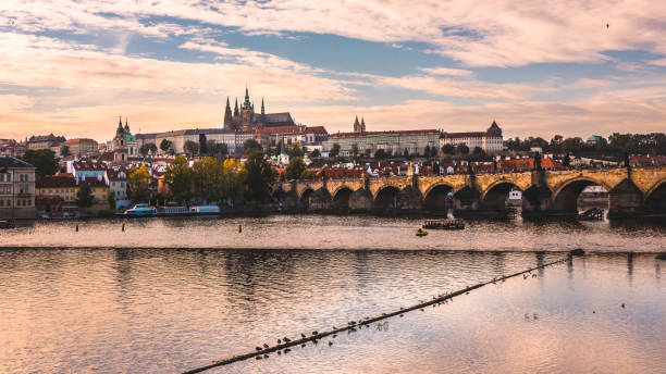 istock Prague castle over Charles Bridge during autumn sunset 1177720431
