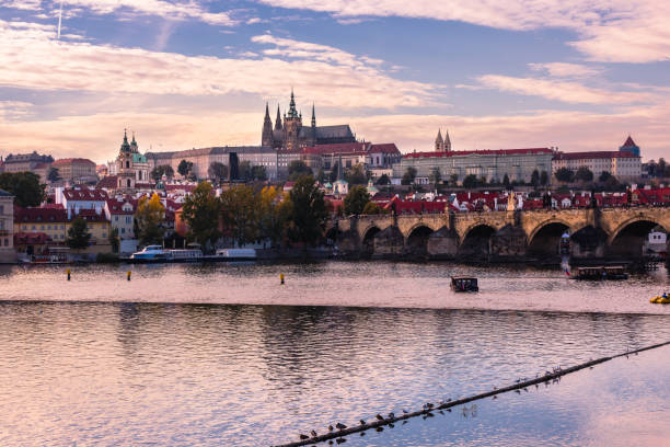 istock Prague castle over Charles Bridge during autumn sunset 1177720435