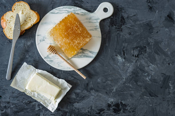 istock Honeycomb on marble plate on black background 1177720788