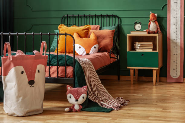 istock Fox theme in cute bedroom interior with green wall and orange bedding 1177722405