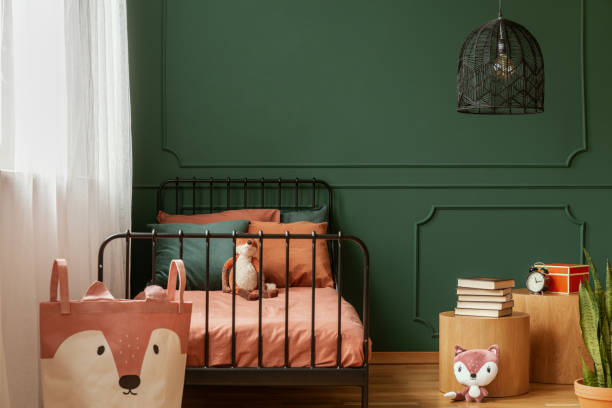 istock Copy space on empty dark green wall of trendy bedroom interior 1177722406
