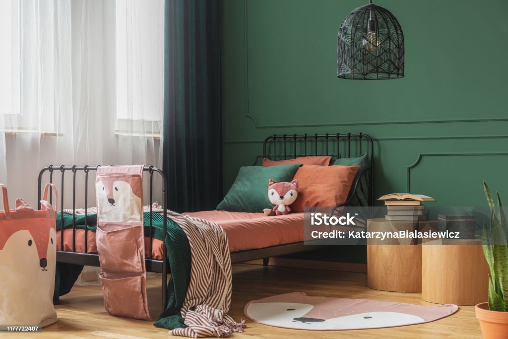Black fancy chandelier in fashionable teenager bedroom with single bed Bedroom Stock Photo