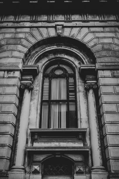 istock Arched window of an abandoned bank 1177725580