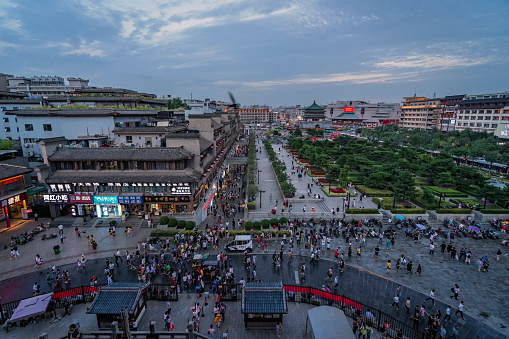 Xian, China -  July 2019 : Crowds walking on streets and town square with landmark Drum Tower in the background, Shaaxi Province
