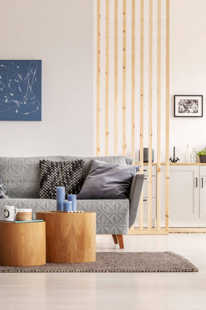 istock Open plan living room and kitchen interior with white cupboards and grey sofa with pillows 1177727630