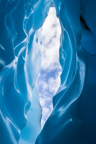 istock Looking up at the sky from inside a narrow crevasse 1177727977