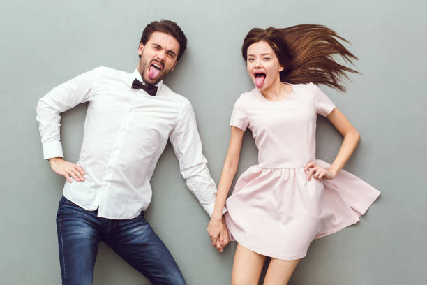 istock Young couple top view isolated on grey background grimacing 1177729499