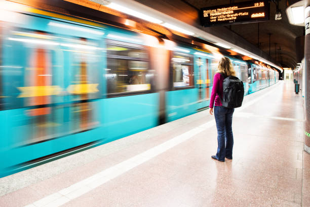 istock Woman waiting at platform, while subway drives by 1177729764