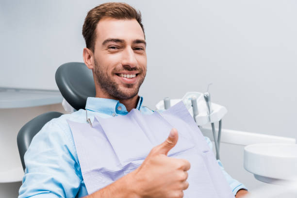 istock happy bearded man smiling while showing thumb up in dental clinic 1177732231
